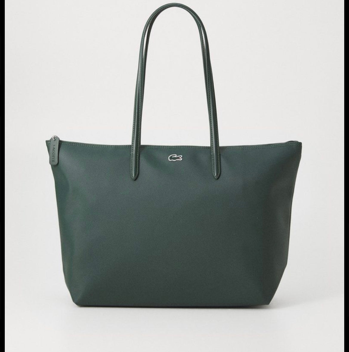 Green handbag with a brand logo on a light gray background