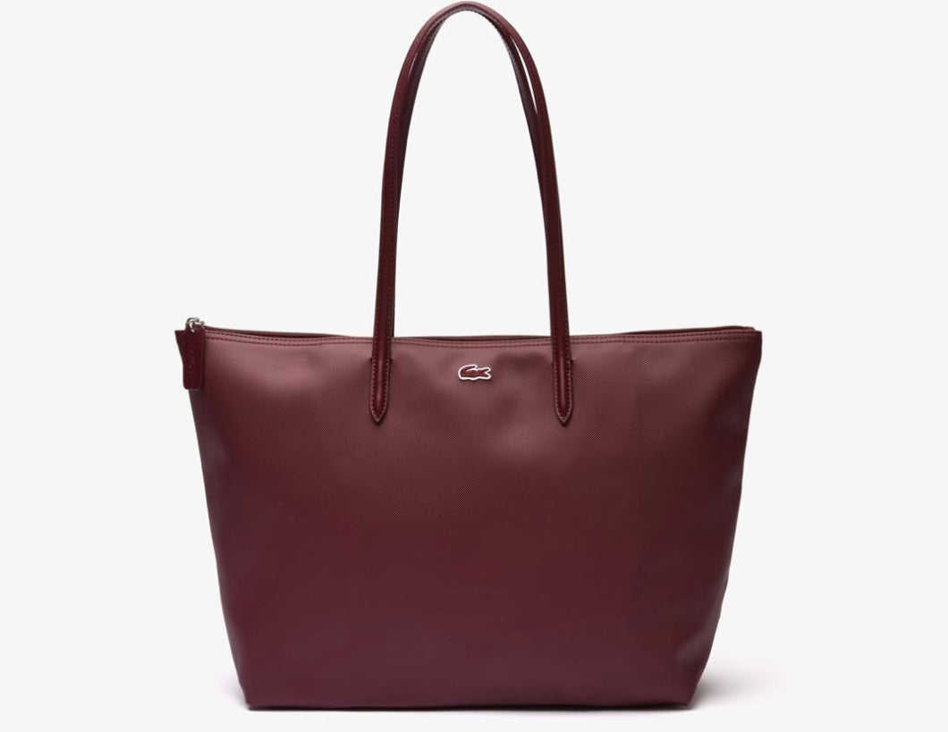 BURGUNDY handbag with a visible brand logo on a white background